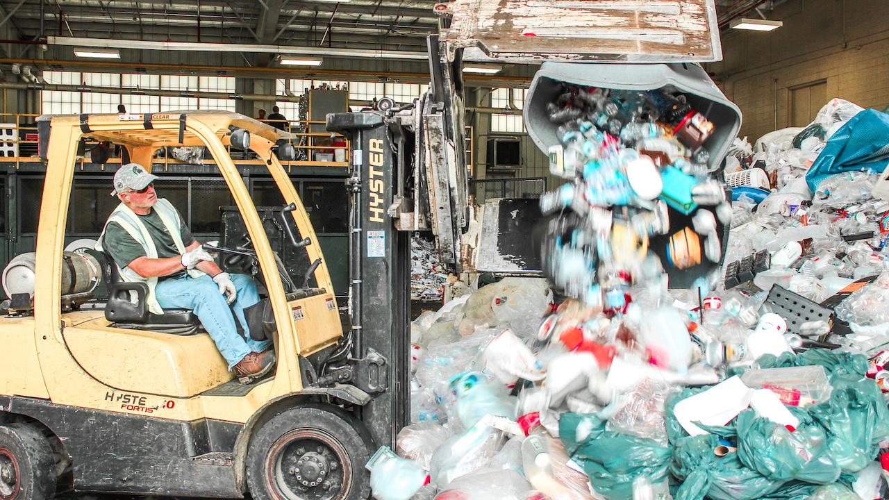 A forklift works to move plastic materials at the Michigan State University Surplus Store and Recycling Center