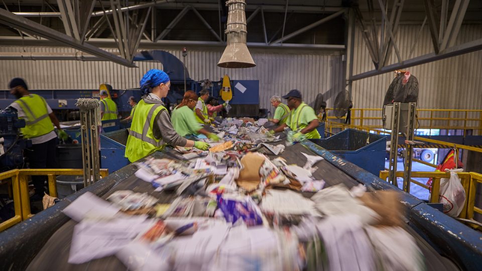 Peopele sorting recycled materials at Kent County Recycling & Education Center