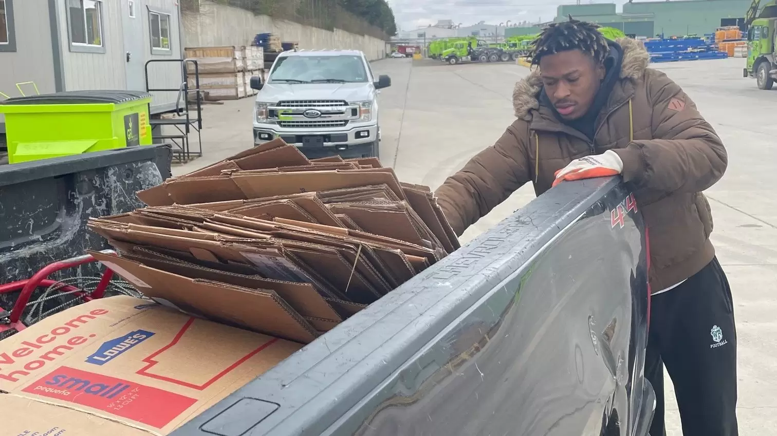 Man loading empty boxes in a truck