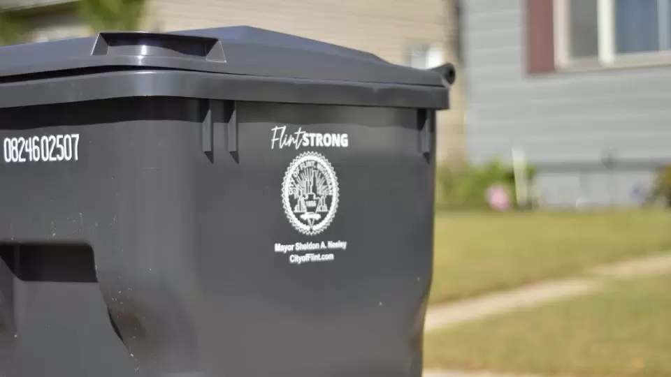 A trash bin outside a house